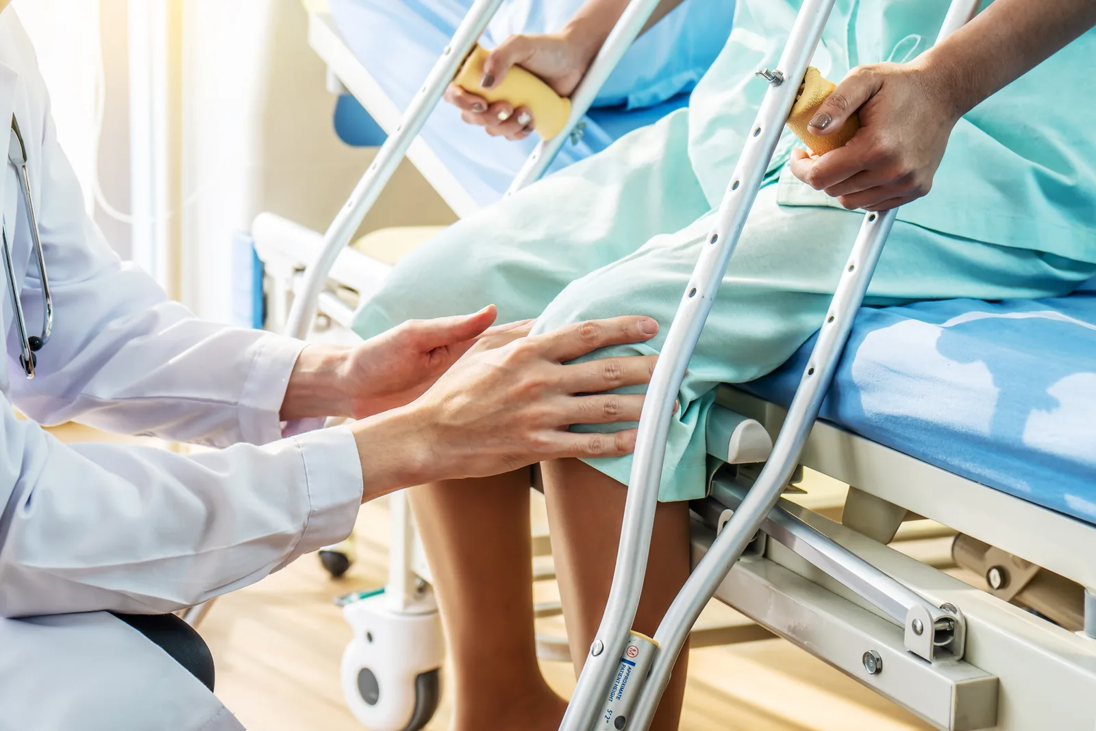 Therapist guiding a patient through an orthopedic rehab exercise